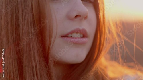 Portrait of a redhead girl at sunset photo