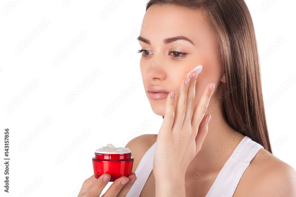 Pretty woman with perfect skin holding a tube with face cream. Young