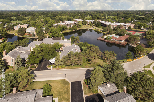 Aerial view of community with pond photo