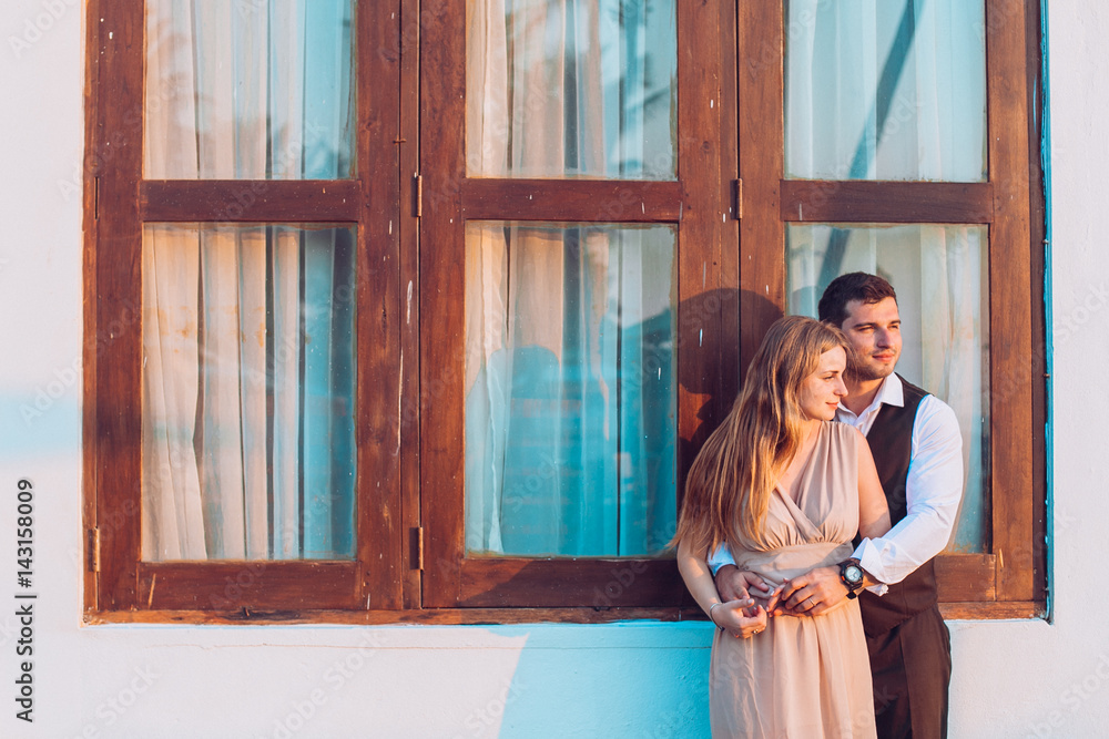 Fototapeta premium lovely couple stay near beach hut around ocean or sea palms and sand.