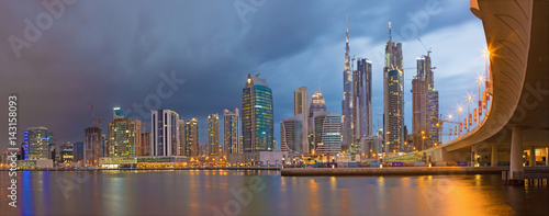 DUBAI  UAE - MARCH 24  2017  The evening skyline with the bridge over the new Canal and Downtown with ths storm clouds.