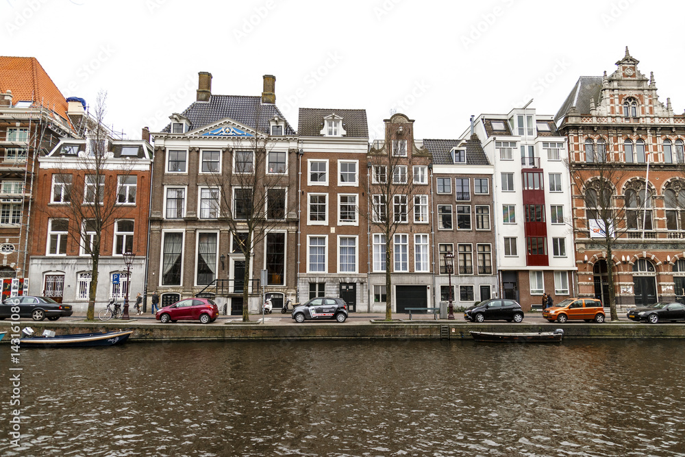 Amsterdam, March 17, 2017: Canals and house view from Amsterdam, where city of bikes, canals and peace
