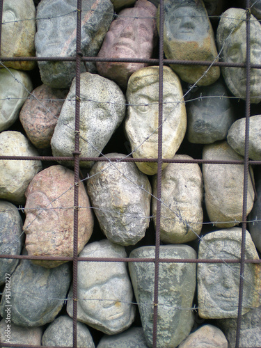 We can see stones of different shapes and faces. There is a net around them. They looks very fascinating.