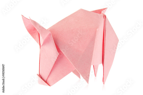 Pink pig of origami, isolated on white background. Stock photo.