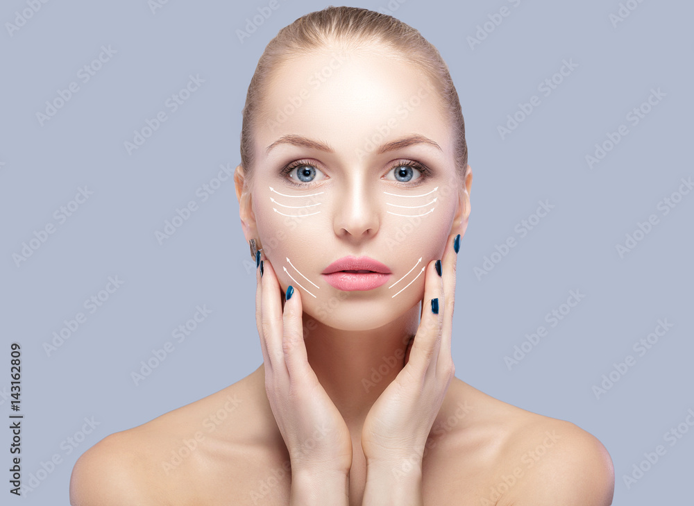 Spa portrait of attractive woman with arrows on face Face lifting concept. Plastic surgery treatment, medicine Spa portrait of attractive woman with arrows on face Face lifting concept. Plastic surgery treatment, medicine