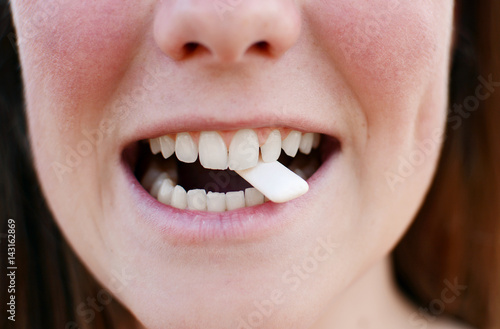 Fotografie Beautiful woman is brushing her teeth and chewing gum.