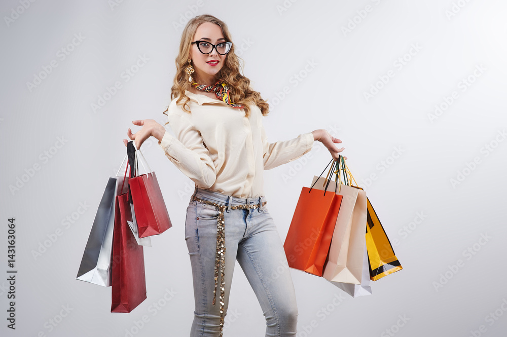 Woman holding shopping bags against a white background Woman holding shopping bags against a white background