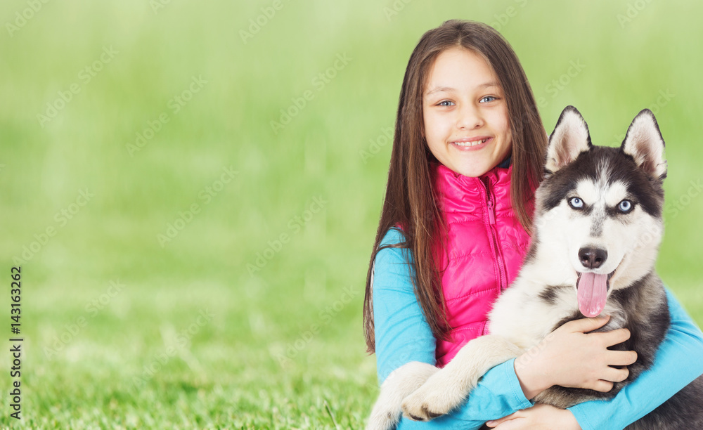 Girl and Siberian husky On the green grass Girl and Siberian husky On the green grass