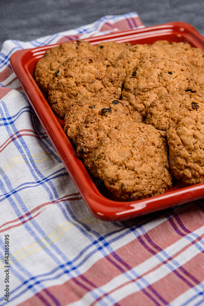 Sweet oatmeal cookies in red tray 