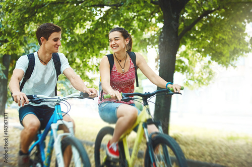 Εκτύπωση καμβά Young people, couple with bicycles in the park