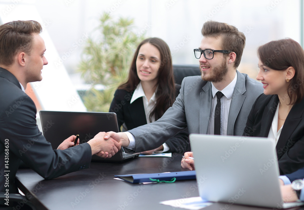 Business people shaking hands, finishing up a meeting Business people shaking hands, finishing up a meeting
