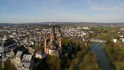 The cathedral of Limburg. On a sunny day an aerial shot of Limburg with its older inner city and the new buildings in the back. The river Lahn can be seen in the foreground. photo
