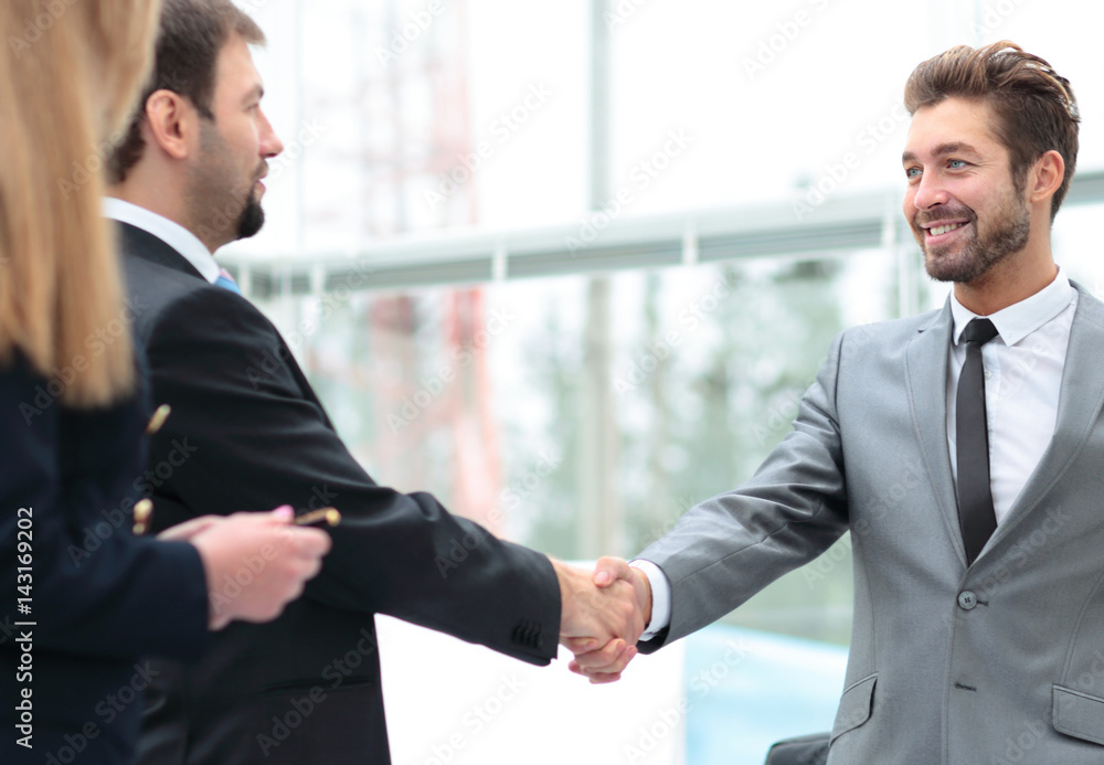 Business people shaking hands, finishing up a meeting Business people shaking hands, finishing up a meeting
