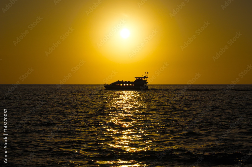 Silhouette of a ship at sunset.