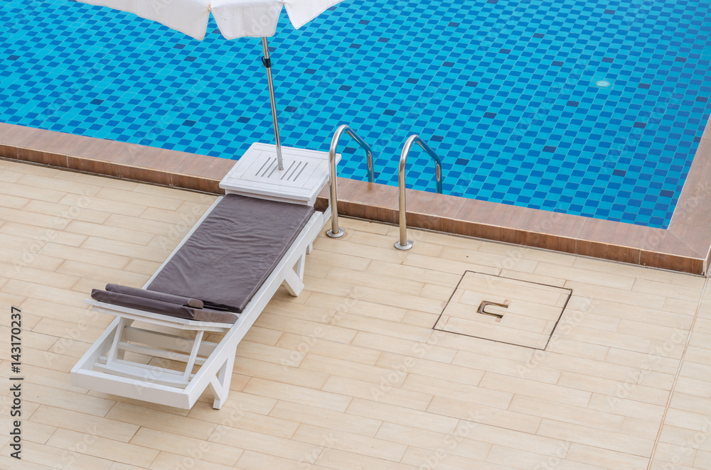 Fototapeta premium Chair and swimming pool in hotel