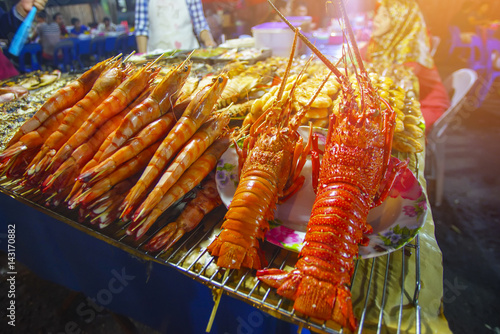 Variety of grilled seafood in Kota Kinabalu night market in Kota Kinabalu, Sabah Borneo, Malaysia. Selective focus, shallow DOF.