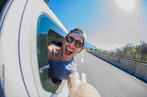 фотографія Handsome man taking a selfie on the road at van trip