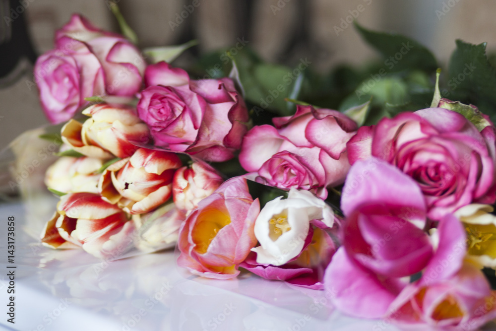 Fototapeta premium Nice tulips and roses on the table