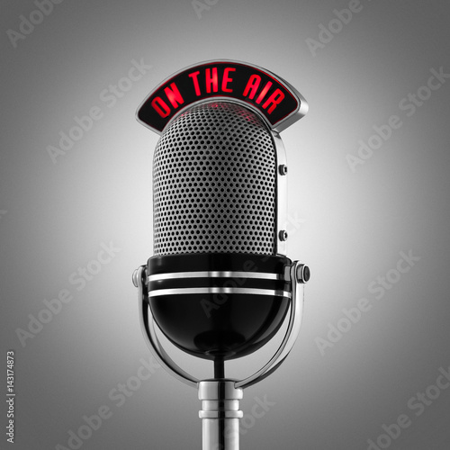 Classical retro microphone on the air with grey background