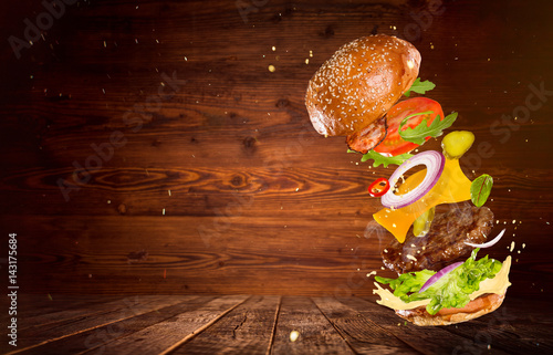 Big tasty burger with flyin...