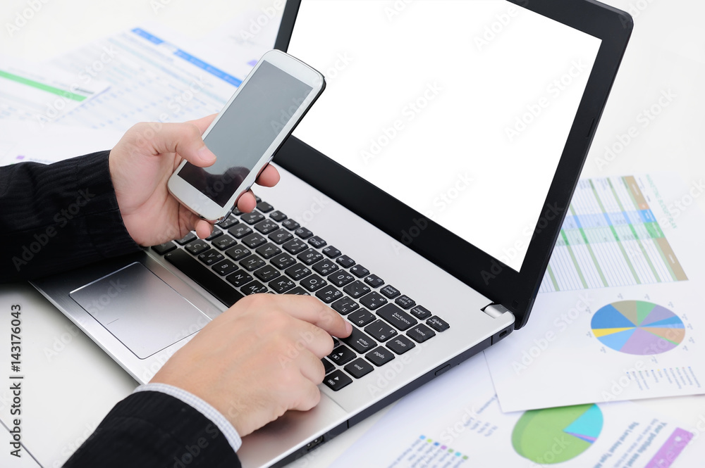 closeup hands businessman using smart phone and laptop