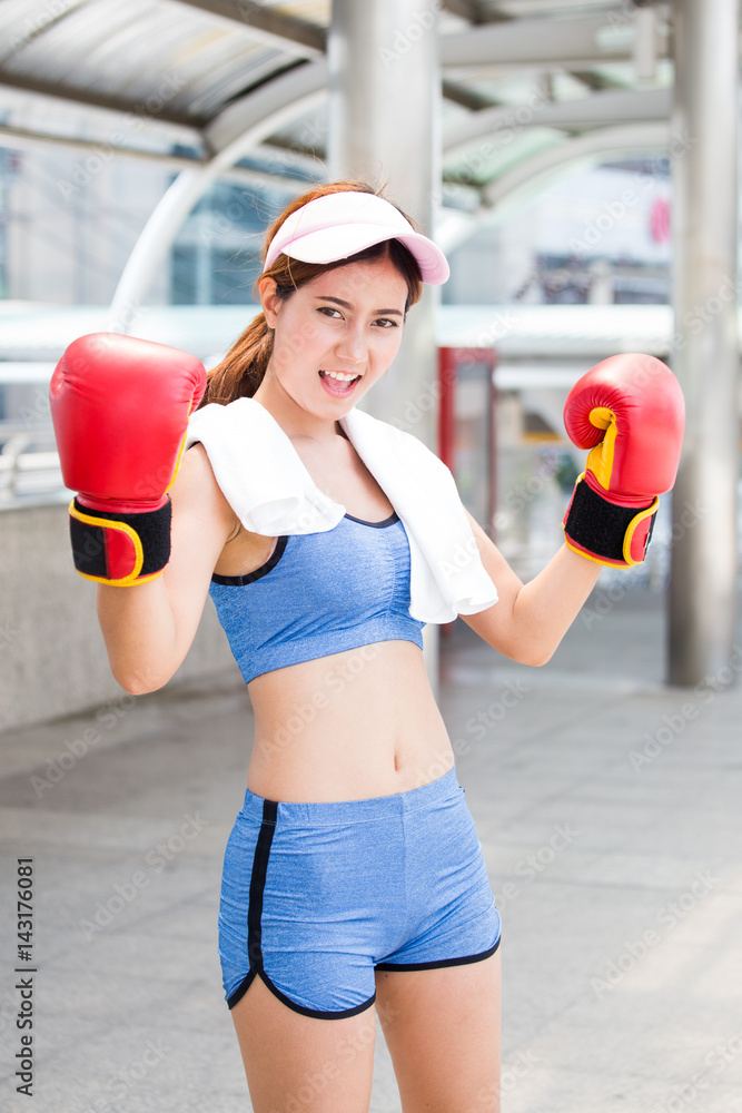 Young asian woman wearing boxing gloves with winer concept.
