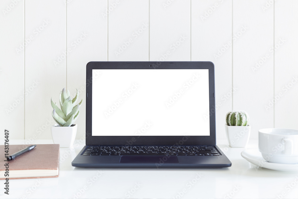 Laptop computer isolated white screen with books, coffee cup and cactus flowers vase on white wooden desk Laptop computer isolated white screen with books, coffee cup and cactus flowers vase on white wooden desk