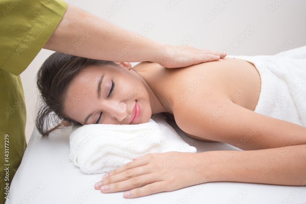 Attractive young and healthy woman on bamboo mat in spa salon is having massage, Spa, health and healing concept. Attractive young and healthy woman on bamboo mat in spa salon is having massage, Spa, health and healing concept.