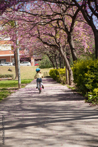 Little girl with her bike in the city