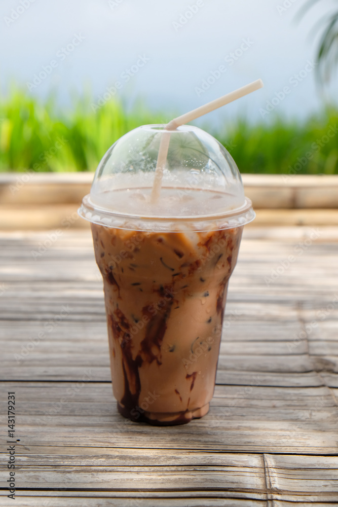 Iced coco or chocolate with straw in plastic cup Iced coco or chocolate with straw in plastic cup