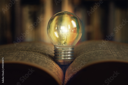 A Light Bulb Placed on an Opened Book