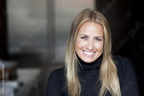 Portrait Of A Mature blond woman smiling at the camera