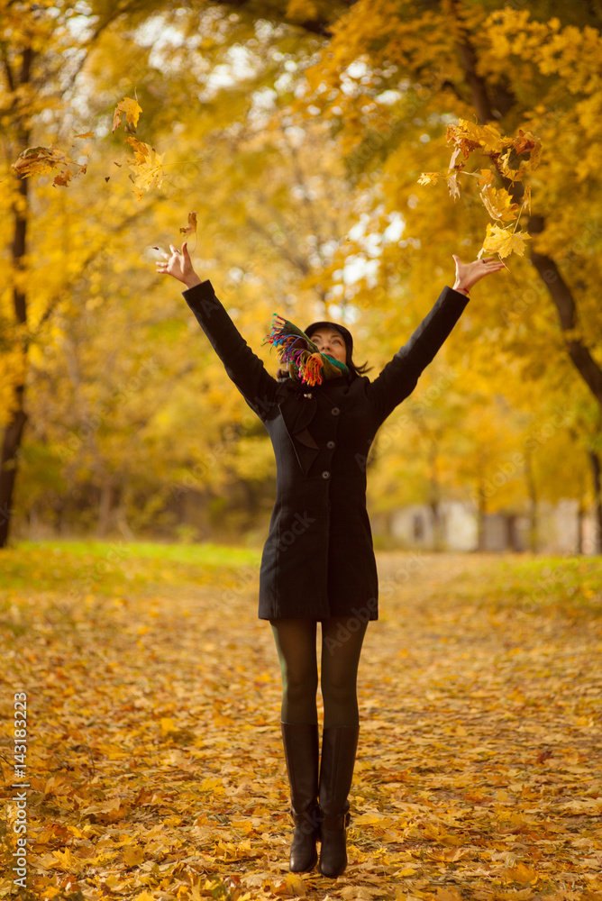 Beautiful brunette woman jumping in autumn park Beautiful brunette woman jumping in autumn park