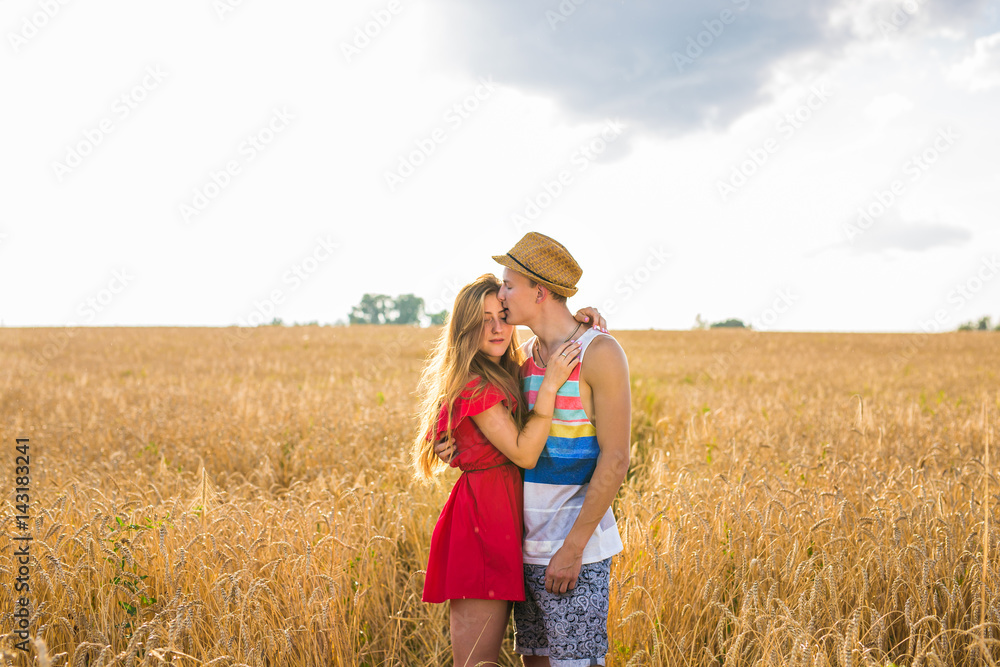 Young couple in love outdoor.Stunning sensual outdoor portrait of young stylish fashion couple posing in summer in field. Young couple in love outdoor.Stunning sensual outdoor portrait of young stylish fashion couple posing in summer in field.