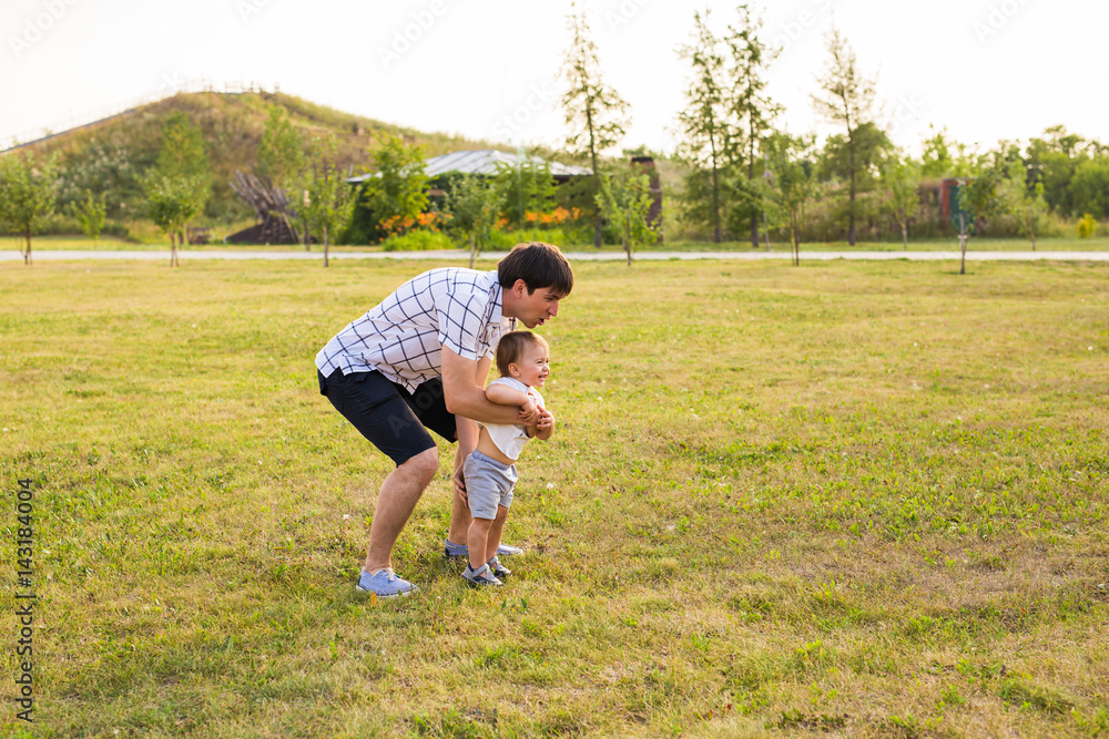happy family father and child on meadow in the summer on the nature happy family father and child on meadow in the summer on the nature