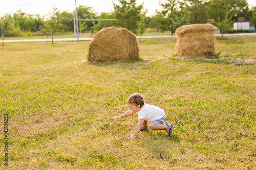little boy playing in summer nature photo