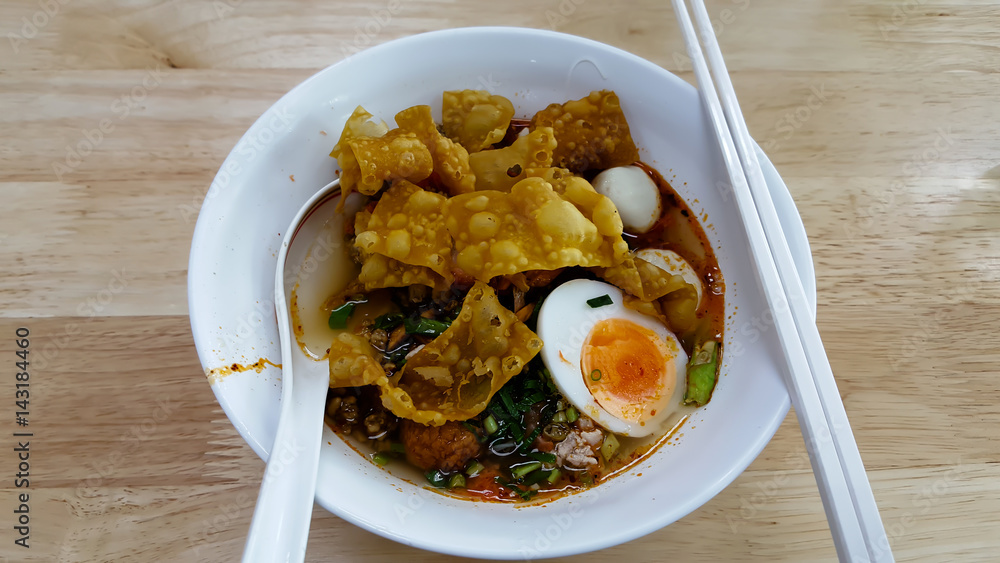 Hot and spicy instant noodle and fork on the table Hot and spicy instant noodle and fork on the table