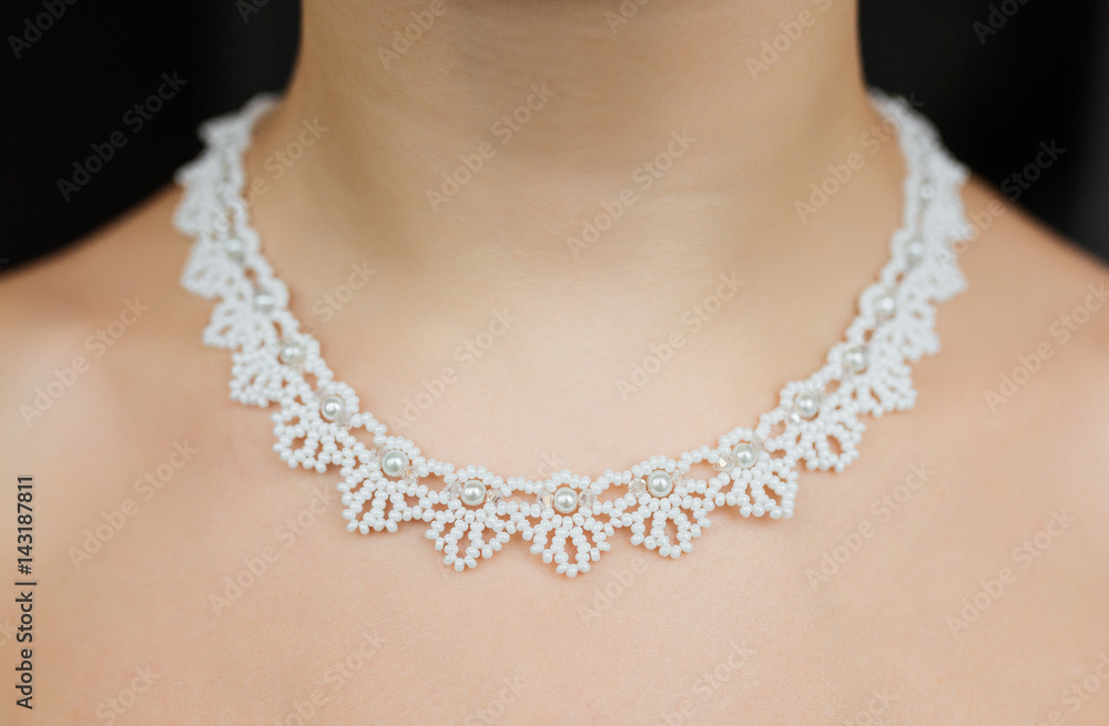 Jewelry concept. Closeup portrait of a wedding necklace on female neck Jewelry concept. Closeup portrait of a wedding necklace on female neck
