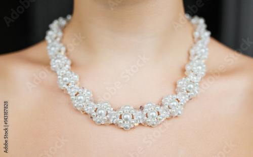 Jewelry concept. Closeup portrait of a wedding necklace on female neck
