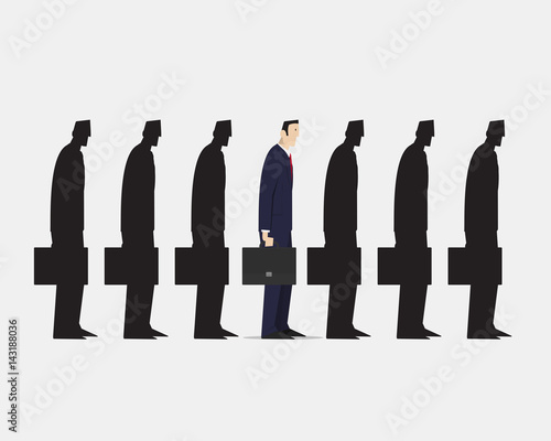 Businessman standing out from crowd.