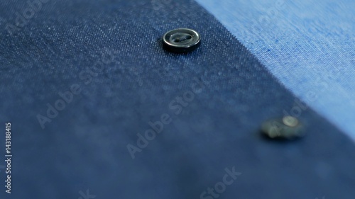 Close up view of smart business women's suit jacket - denim, texture, buttons