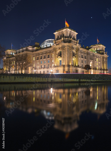 Berlin - The Reichstag building at dusk over the Spree river at night