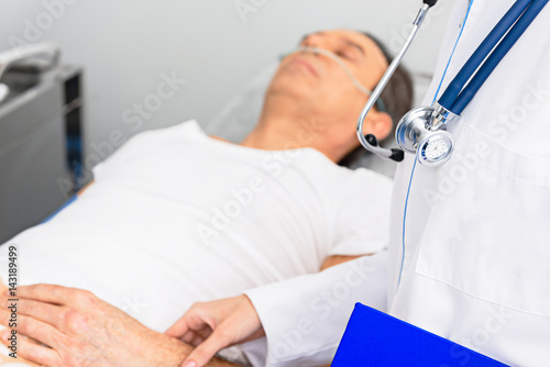 Physician taking pressure of serene client