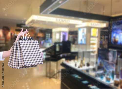 Beauty Woman with Shopping Bags in Shopping Mall. Shopper. Sales. Shopping Center..