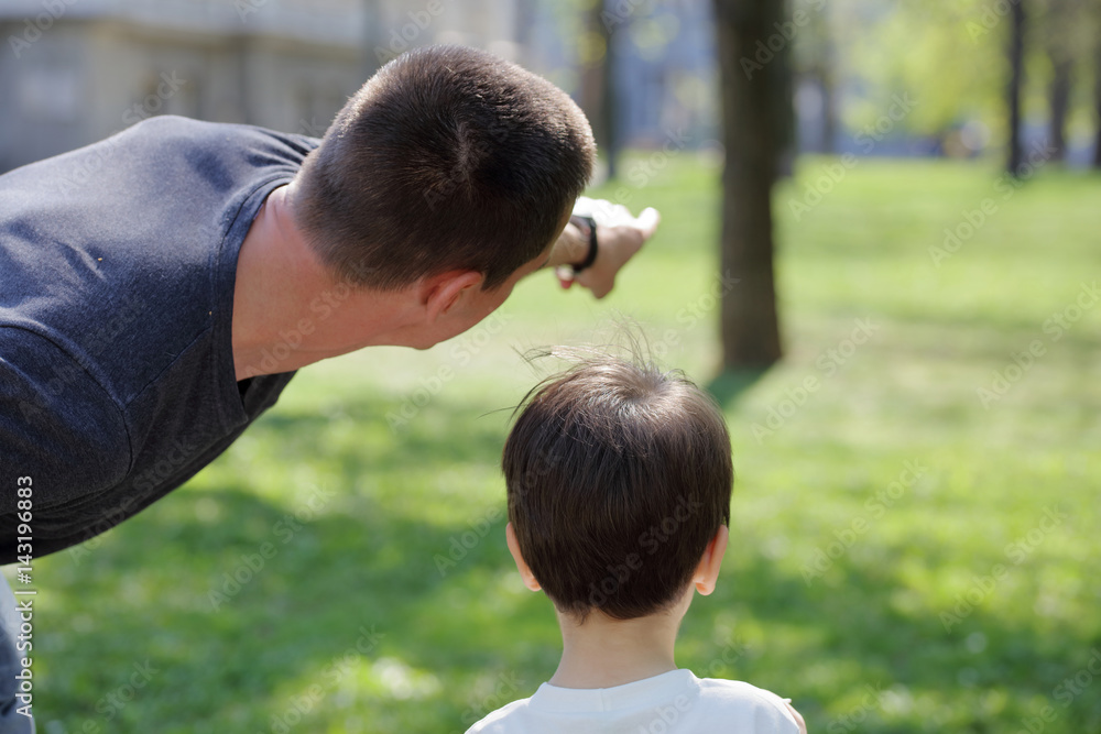 Father and his son in park enjoying time together Father and his son in park enjoying time together