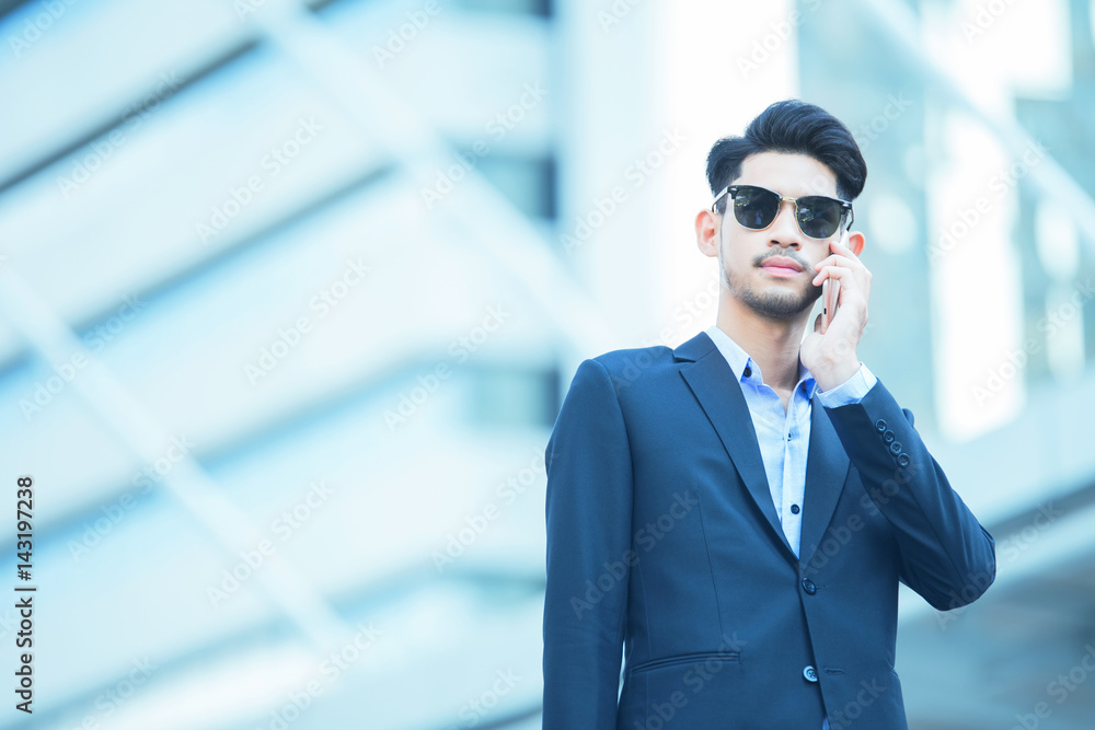 Business man holding smart phone for calling, working on the outdoor Business man holding smart phone for calling, working on the outdoor