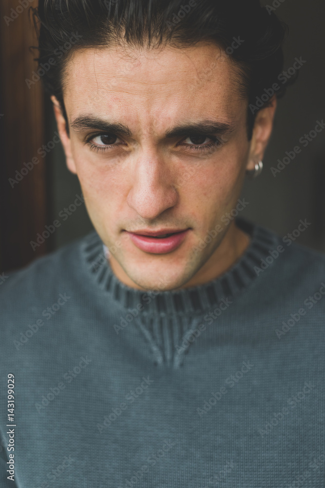 Portrait of handsome young man indoor looking camera - customer, serene, attitude concept Portrait of handsome young man indoor looking camera - customer, serene, attitude concept