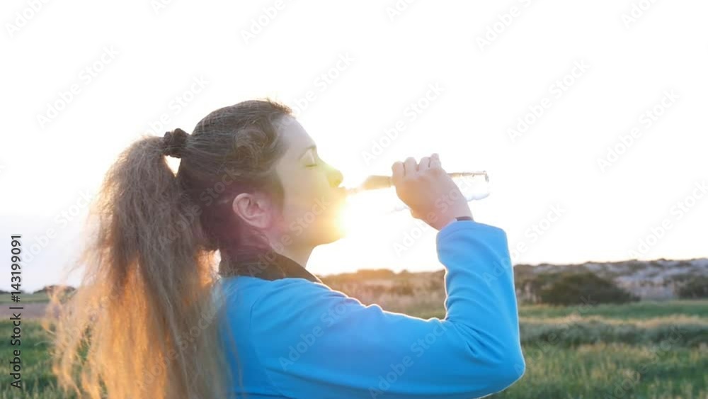 Beautiful fitness athlete woman drinking water after work out exercising Beautiful fitness athlete woman drinking water after work out exercising