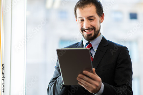 Portrait of a confident business man holding his tablet