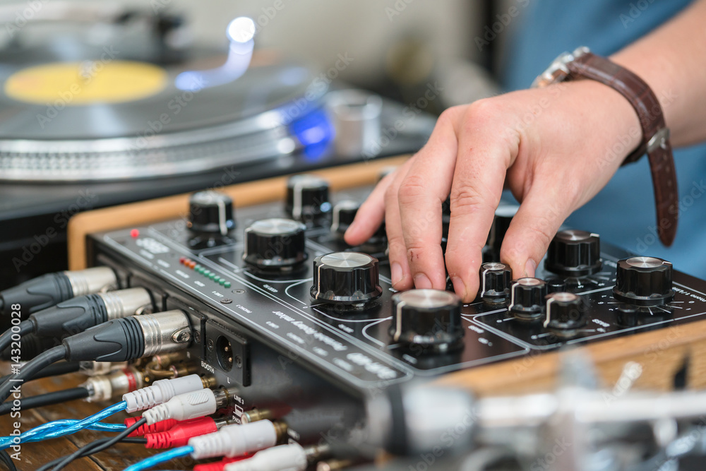 Dj play music at hip hop party.Turntable vinyl record player,analog sound technology for disc jockey to scratch vinyl records and mix tracks Dj play music at hip hop party.Turntable vinyl record player,analog sound technology for disc jockey to scratch vinyl records and mix tracks